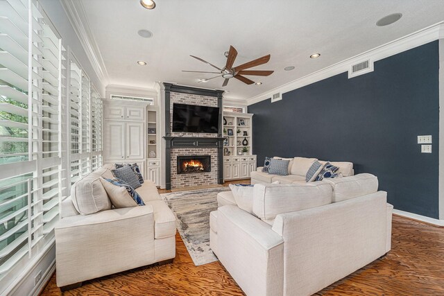 13602 Springmint Dr, Cypress, TX 77429 - living area featuring a ceiling fan, crown molding, recessed lighting, wood finished floors, and a brick fireplace