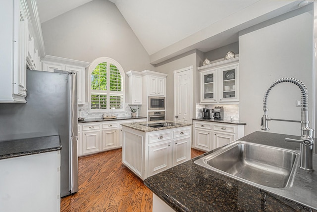 13602 Springmint Dr, Cypress, TX 77429 - kitchen featuring black appliances, white cabinetry, decorative backsplash, high vaulted ceiling, and wood finished floors