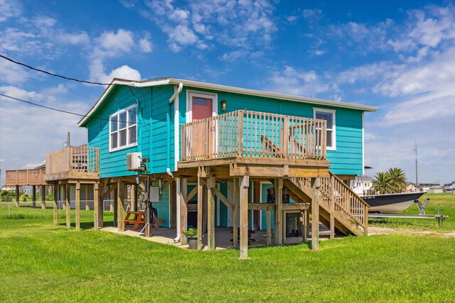 4014 2nd St, Galveston, TX 77554 - back of property with a wooden deck, a lawn, and stairs