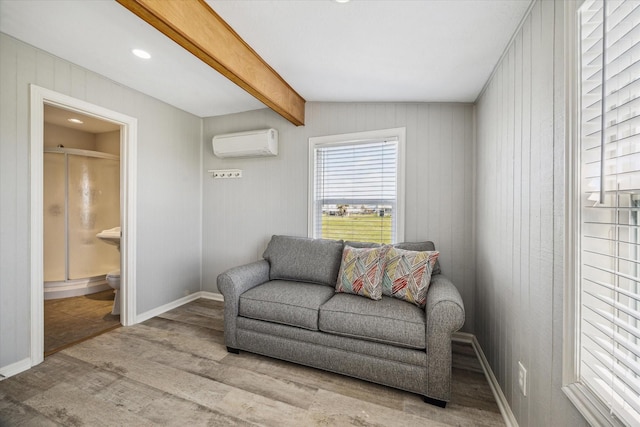 4014 2nd St, Galveston, TX 77554 - sitting room with a wall unit AC, wood finished floors, beamed ceiling, and wood walls
