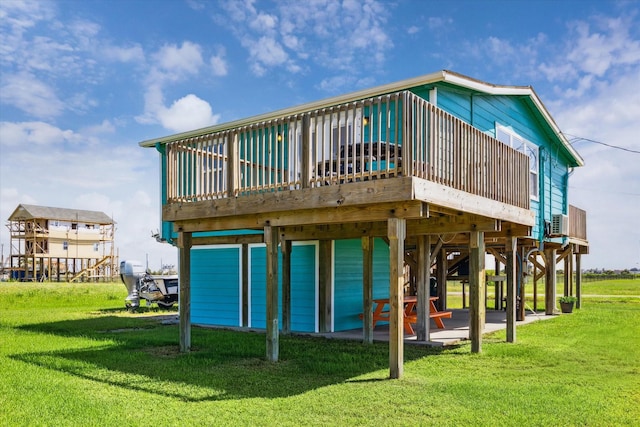 4014 2nd St, Galveston, TX 77554 - rear view of property with a yard, a wooden deck, and a patio