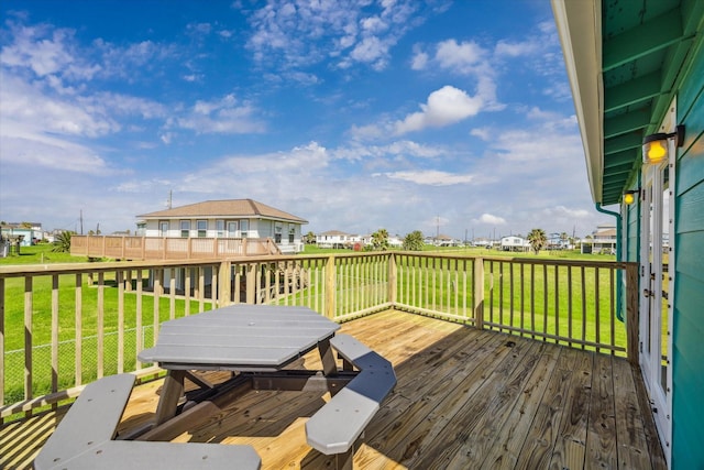 4014 2nd St, Galveston, TX 77554 - wooden terrace featuring outdoor dining space, a lawn, and a residential view