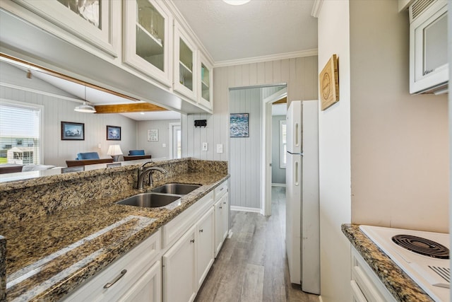 4014 2nd St, Galveston, TX 77554 - kitchen featuring white appliances, light wood-style flooring, glass insert cabinets, white cabinets, and dark stone countertops