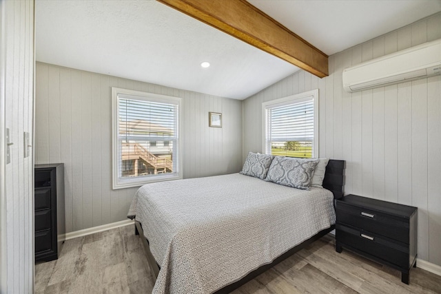 4014 2nd St, Galveston, TX 77554 - bedroom featuring a wall mounted air conditioner, wood finished floors, and wooden walls