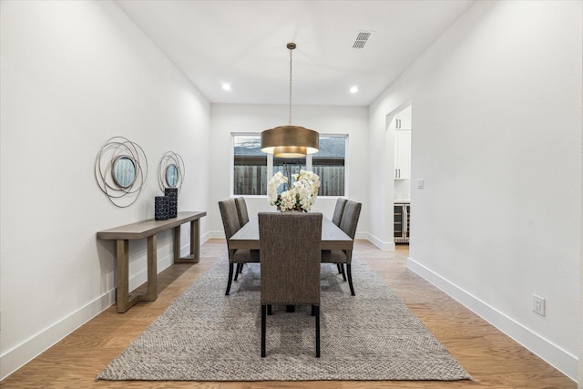 1132 Wakefield Dr, Houston, TX 77018 - dining space with wine cooler, recessed lighting, and light wood-type flooring