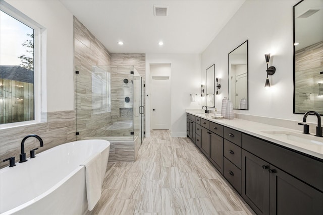 1132 Wakefield Dr, Houston, TX 77018 - bathroom featuring a soaking tub, a stall shower, double vanity, marble finish flooring, and recessed lighting