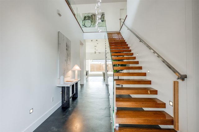 909 Peden St, Houston, TX 77006 - stairway with concrete floors, a towering ceiling, and a chandelier