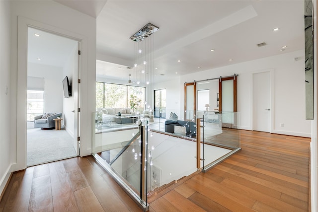 909 Peden St, Houston, TX 77006 - interior space featuring light wood-style flooring, a barn door, and recessed lighting