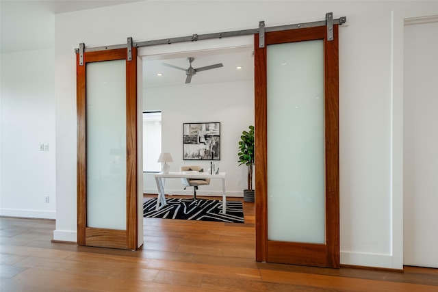 909 Peden St, Houston, TX 77006 - hallway with a barn door, an office area, recessed lighting, and wood finished floors