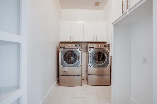 909 Peden St, Houston, TX 77006 - washroom with washing machine and dryer and cabinet space