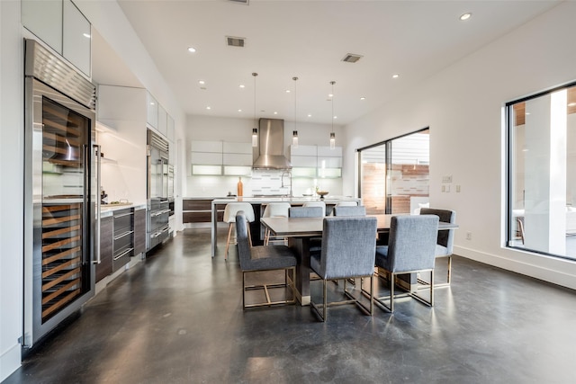 909 Peden St, Houston, TX 77006 - dining room featuring beverage cooler, recessed lighting, and concrete flooring