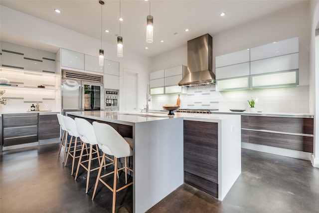 909 Peden St, Houston, TX 77006 - kitchen featuring wall chimney range hood, modern cabinets, concrete floors, stainless steel built in fridge, and tasteful backsplash