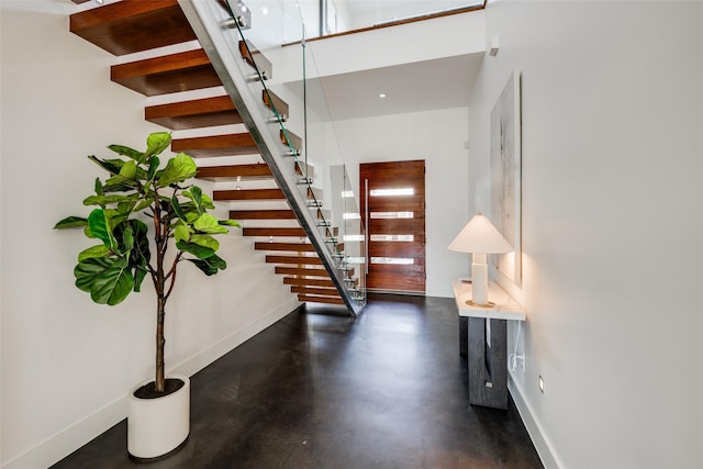 909 Peden St, Houston, TX 77006 - stairway featuring baseboards and concrete floors