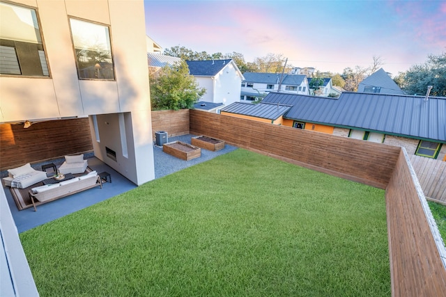 909 Peden St, Houston, TX 77006 - yard at dusk with a fenced backyard, a patio, a residential view, and an outdoor hangout area