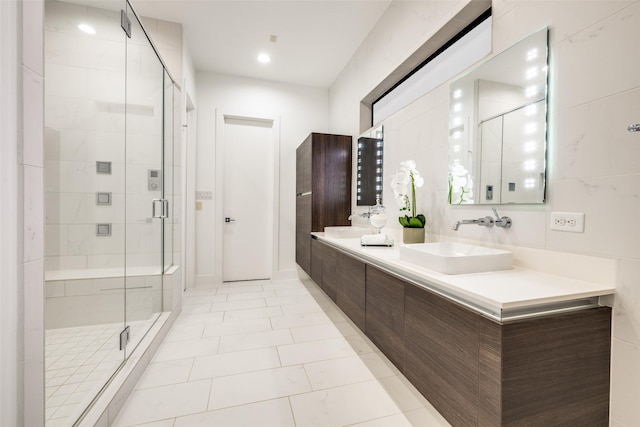 909 Peden St, Houston, TX 77006 - bathroom with double vanity, a shower stall, and tile patterned floors