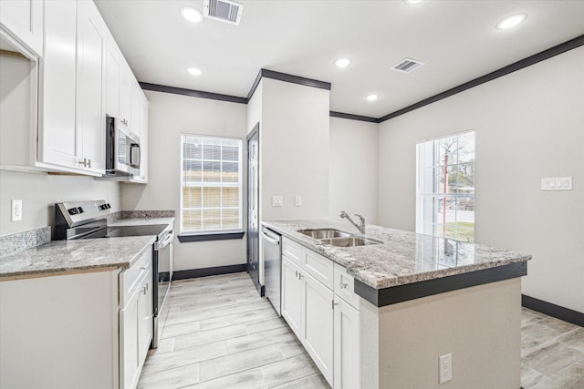 9412 Crofton St, Houston, TX 77016 - kitchen featuring stainless steel appliances, a peninsula, white cabinets, recessed lighting, and light stone countertops