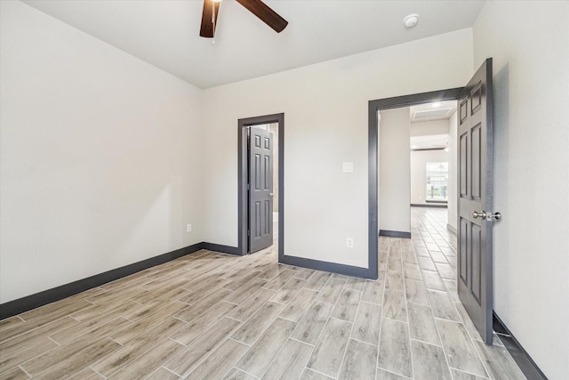 9412 Crofton St, Houston, TX 77016 - spare room with a ceiling fan, light wood-style floors, a smoke detector, and a wall unit AC