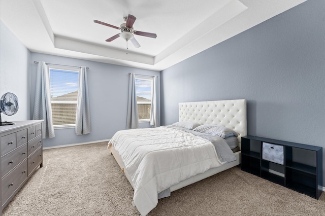 4330 Barchetta Trl, Katy, TX 77493 - bedroom featuring light carpet, a tray ceiling, and a ceiling fan