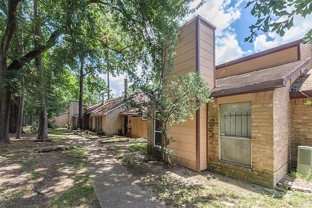 12254 Wild Pine Dr Unit A, Houston, TX 77039 - view of side of home with brick siding and a chimney