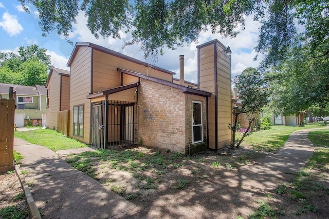 12254 Wild Pine Dr Unit A, Houston, TX 77039 - rear view of house with brick siding and a chimney