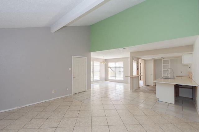 12254 Wild Pine Dr Unit A, Houston, TX 77039 - unfurnished living room with beam ceiling, light tile patterned floors, a chandelier, and high vaulted ceiling