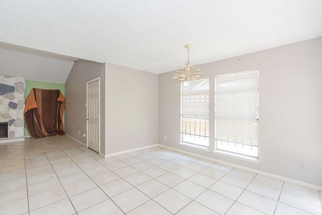 12254 Wild Pine Dr Unit A, Houston, TX 77039 - unfurnished room with a chandelier, light tile patterned flooring, vaulted ceiling, and a textured ceiling
