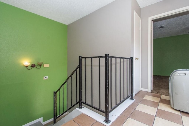 12254 Wild Pine Dr Unit A, Houston, TX 77039 - stairway featuring tile patterned floors and a textured ceiling