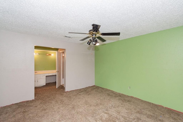 12254 Wild Pine Dr Unit A, Houston, TX 77039 - unfurnished bedroom featuring carpet flooring, a textured ceiling, built in study area, connected bathroom, and a ceiling fan