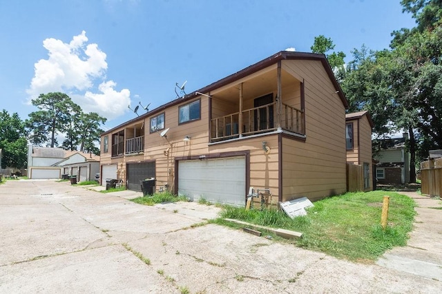 12254 Wild Pine Dr Unit A, Houston, TX 77039 - view of property with a garage, a balcony, and driveway