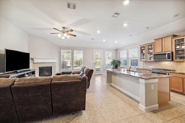 714 Fresh Sage Xing, Richmond, TX 77406 - kitchen with stainless steel appliances, open floor plan, plenty of natural light, stone countertops, and recessed lighting