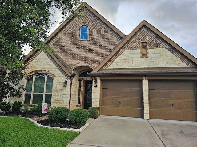 4006 Trento Ct, Katy, TX 77493 - french country home with stone siding, concrete driveway, and brick siding