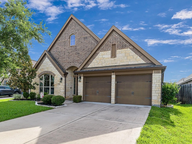 4006 Trento Ct, Katy, TX 77493 - french country inspired facade with stone siding, concrete driveway, a garage, and brick siding