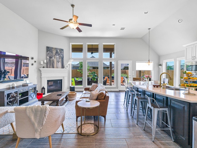 4006 Trento Ct, Katy, TX 77493 - living area featuring ceiling fan, a glass covered fireplace, recessed lighting, and high vaulted ceiling