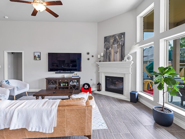4006 Trento Ct, Katy, TX 77493 - living room featuring ceiling fan, wood finish floors, and a glass covered fireplace
