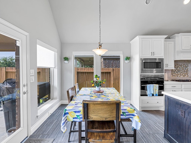 4006 Trento Ct, Katy, TX 77493 - kitchen featuring stainless steel appliances, vaulted ceiling, white cabinets, backsplash, and plenty of natural light