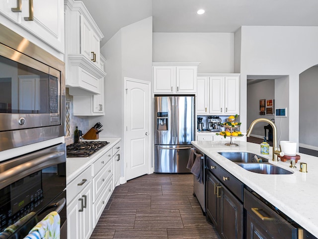 4006 Trento Ct, Katy, TX 77493 - kitchen featuring appliances with stainless steel finishes, white cabinetry, backsplash, recessed lighting, and light stone counters