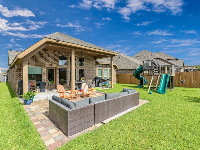 4006 Trento Ct, Katy, TX 77493 - back of house with an outdoor living space, a playground, a patio area, and brick siding