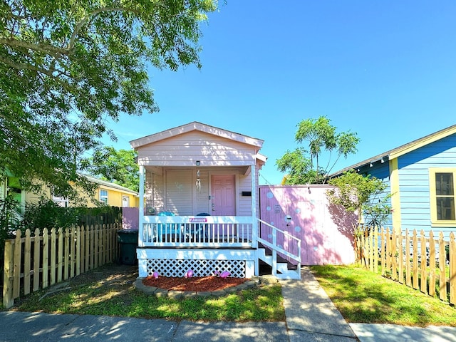1309 55th St, Galveston, TX 77551 - shotgun-style home featuring a porch