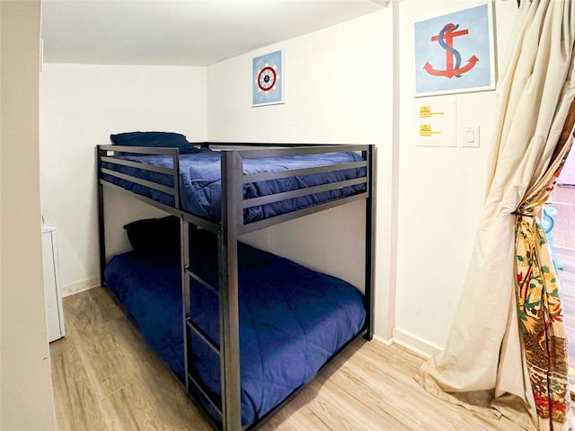 1309 55th St, Galveston, TX 77551 - bedroom with light wood finished floors and baseboards