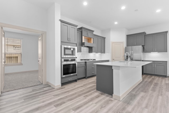 6226 Pelican Ridge Way, League City, TX 77573 - kitchen with appliances with stainless steel finishes, gray cabinetry, light countertops, recessed lighting, and light wood finished floors