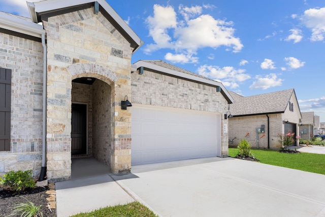 6226 Pelican Ridge Way, League City, TX 77573 - view of front of home featuring a garage, driveway, stone siding, and brick siding