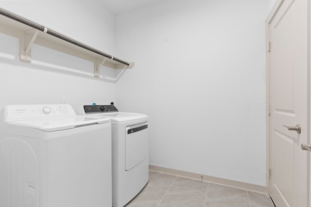 6226 Pelican Ridge Way, League City, TX 77573 - washroom with washing machine and clothes dryer and light tile patterned floors