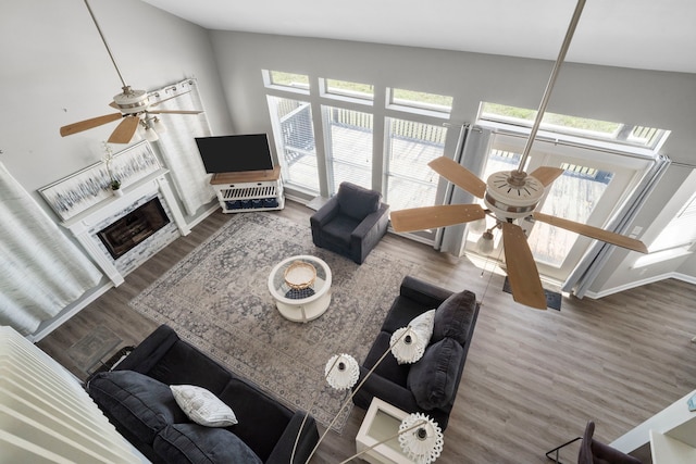 23401 Termini San Luis Pass Rd, Galveston, TX 77554 - living area with ceiling fan, wood finished floors, a fireplace, and vaulted ceiling