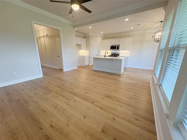 6715 Arbor Way, Orange, TX 77630 - kitchen featuring stainless steel appliances, light wood-style flooring, open floor plan, white cabinets, and a ceiling fan