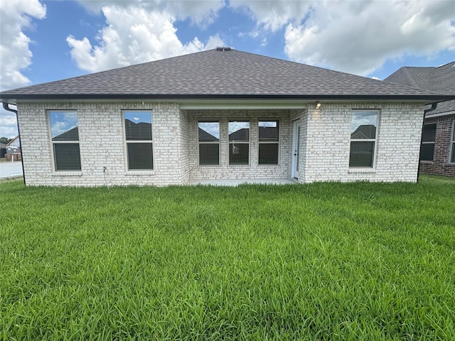 6715 Arbor Way, Orange, TX 77630 - rear view of house with roof with shingles, brick siding, and a lawn