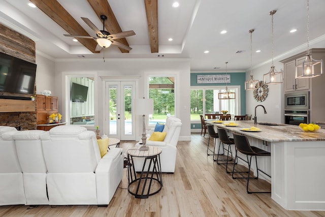 27647 N Salado Ct, Splendora, TX 77372 - living room with light wood-style floors, ornamental molding, recessed lighting, ceiling fan, and beam ceiling