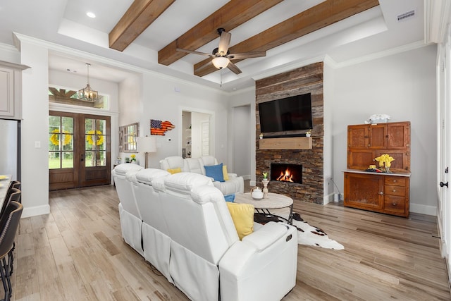 27647 N Salado Ct, Splendora, TX 77372 - living area featuring light wood-style flooring, a ceiling fan, a stone fireplace, beam ceiling, and french doors