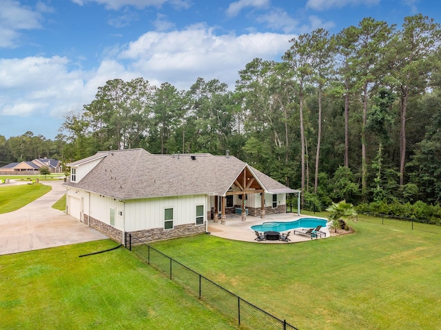 27647 N Salado Ct, Splendora, TX 77372 - back of property with stone siding, roof with shingles, a garage, a patio, and board and batten siding