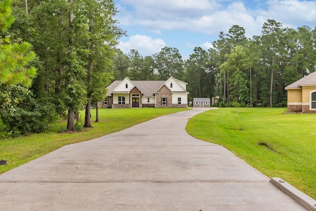 27647 N Salado Ct, Splendora, TX 77372 - view of front of house featuring stone siding, driveway, and a front yard