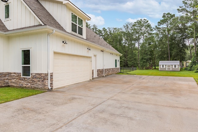 27647 N Salado Ct, Splendora, TX 77372 - view of home's exterior featuring a shingled roof, stone siding, driveway, and board and batten siding